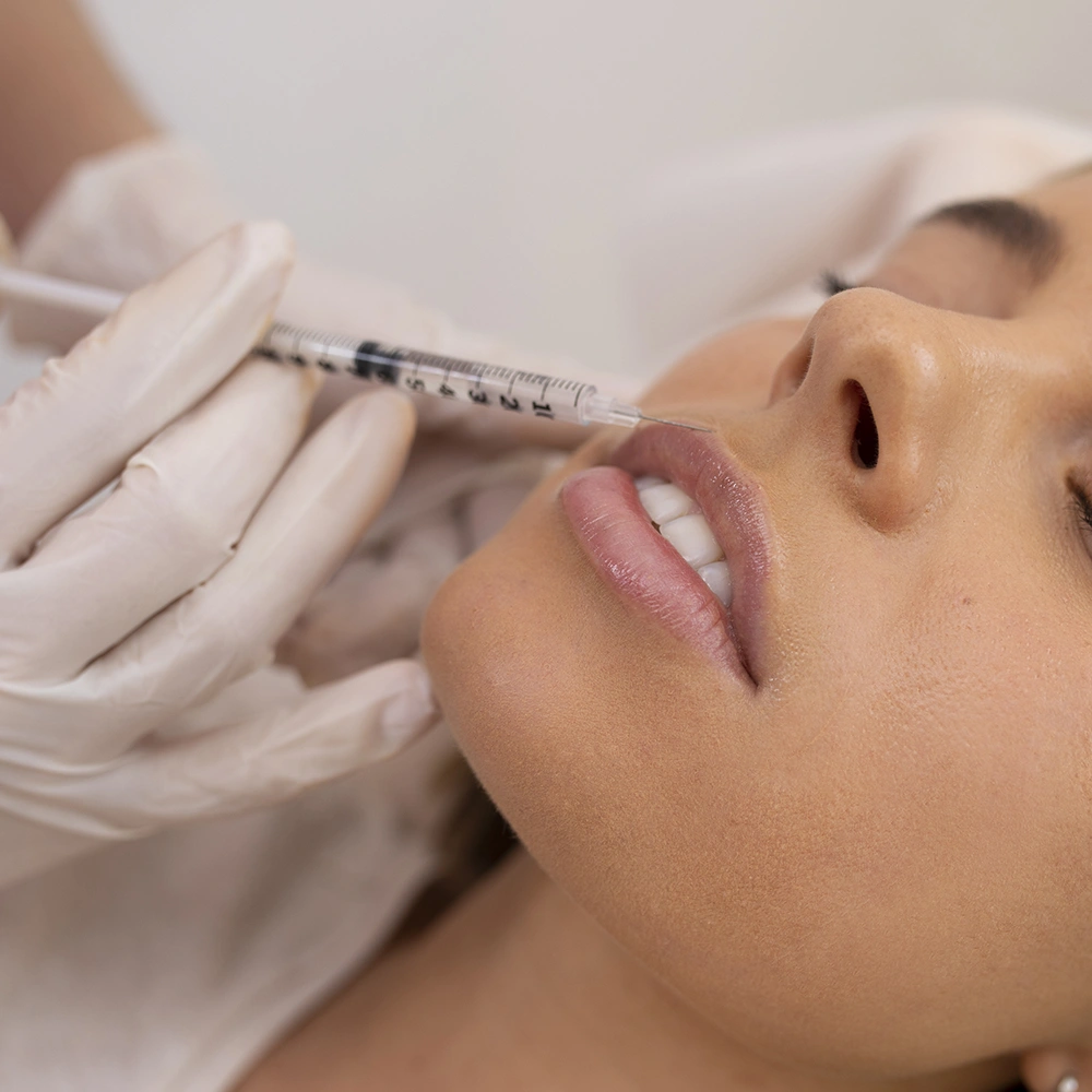 Young woman receiving dermal filler injections for facial volume and rejuvenation